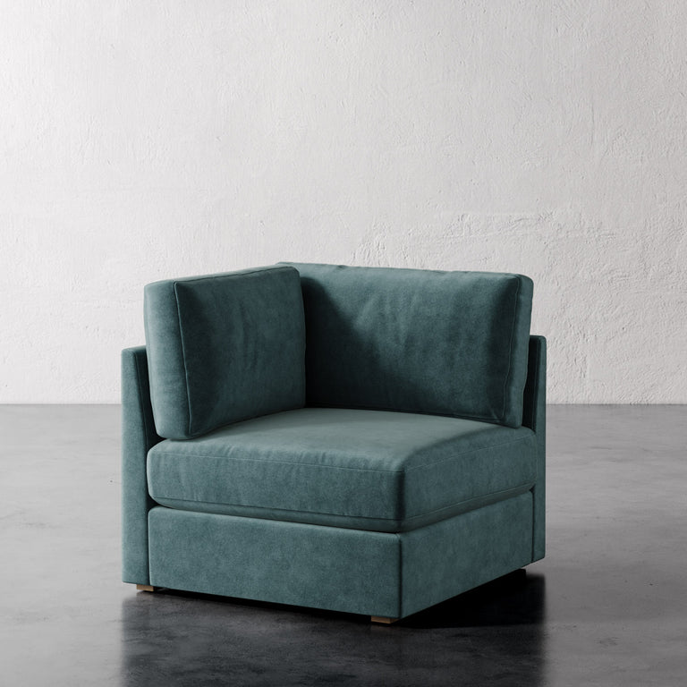 Lemieux Et Cie Chanaux Corner Chair
Teal armchair on a gray floor with a white textured wall background