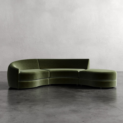 Curved green sofa against a plain wall Rulmann 3-Piece Left Sectional Emerals