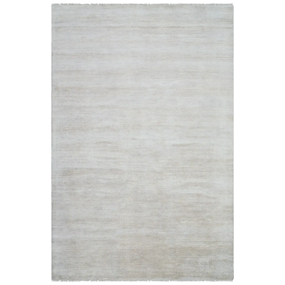 Lemieux et Cie Rochefort Handmade Wool Rug in ivory, handwoven wool rug with soft textured weave and raw fringed edges, shown on white studio backdrop.