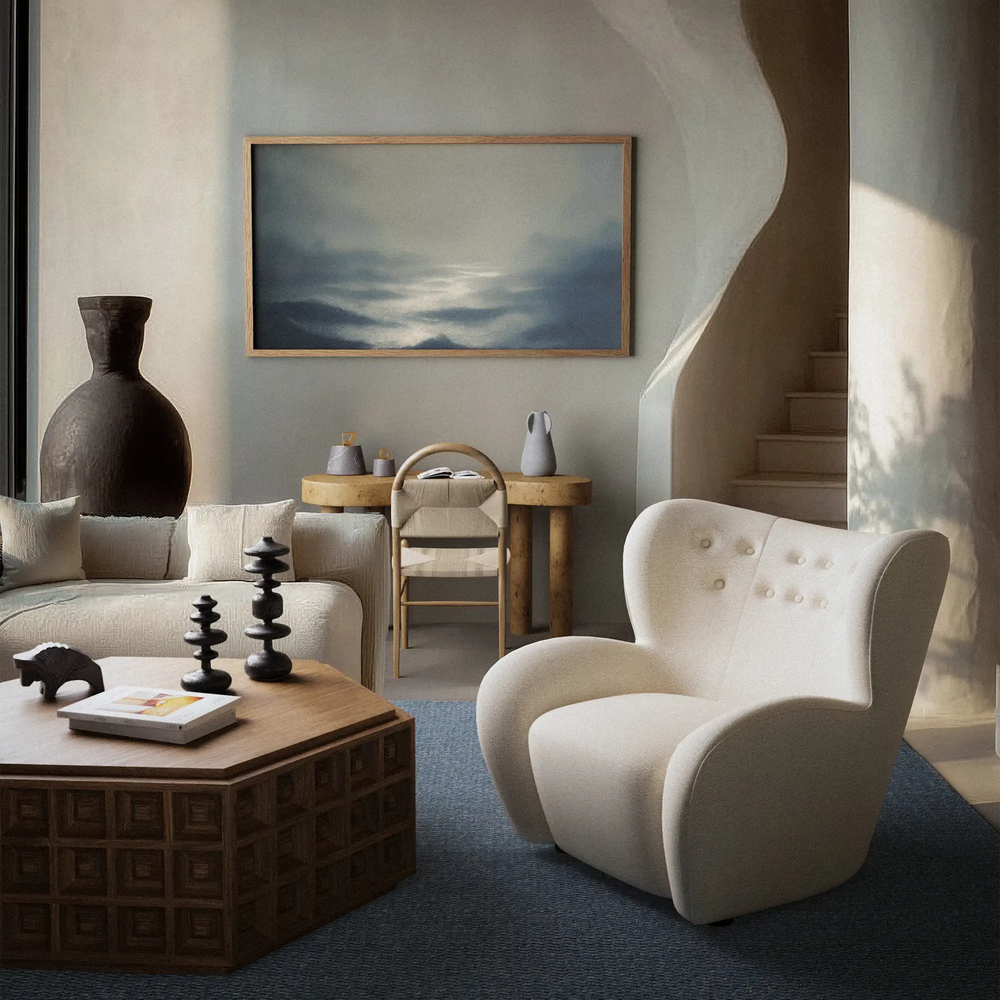 Lemieux et Cie Honfleur Limited Edition Art Print, framed artwork with atmospheric seascape, displayed above sofa in neutral sitting room with blue carpet and warm daylight.