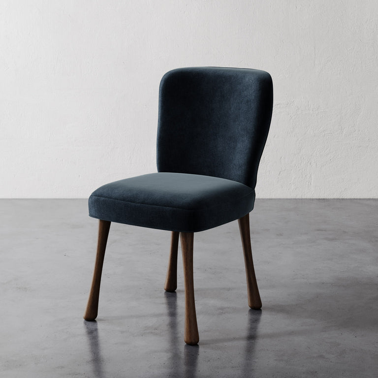 A dark gray upholstered Rozette dining chair with a curved seat and wooden legs, against a neutral background.