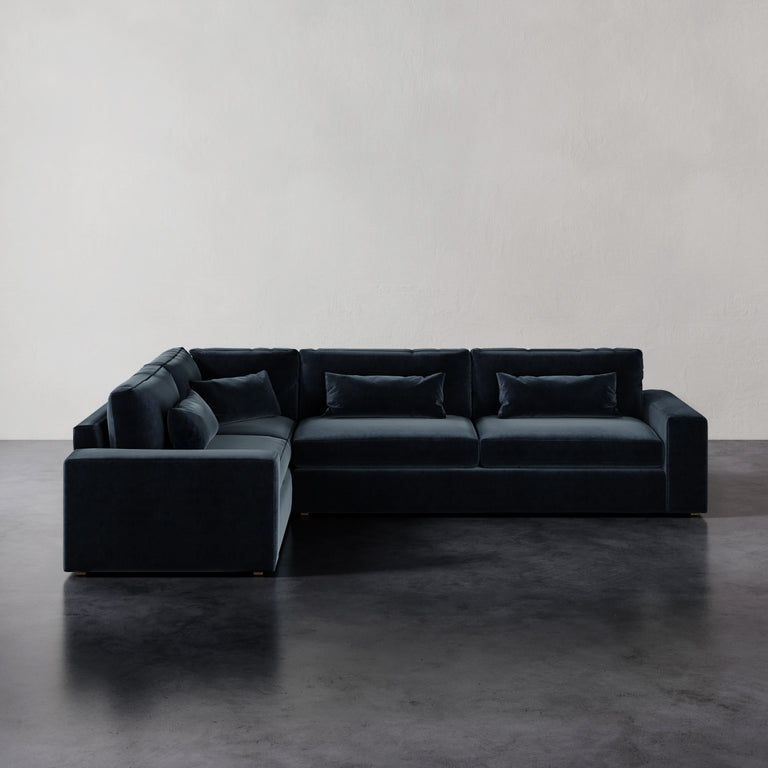 Lemieux et Cie Lacroix Right Arm Sectional, L-shaped modular sofa with bolster pillows, shown on dark concrete floor against neutral walls.