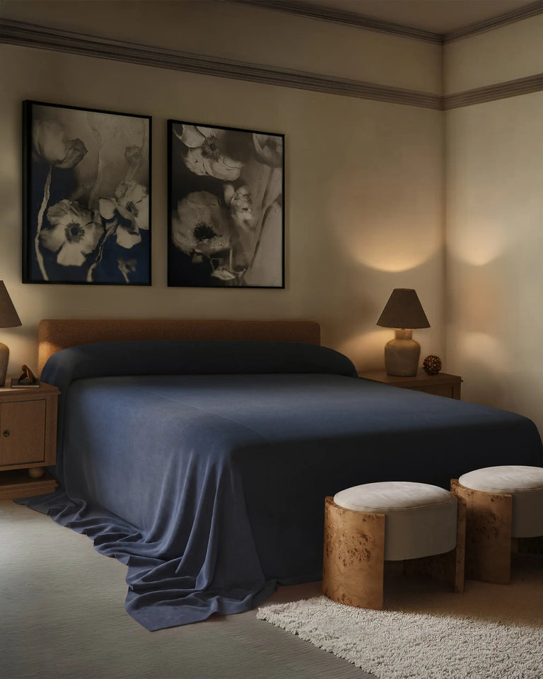 Bedroom with the Herbier Un and Deux limited edition prints hung over a bed with the heavy linen coverlet indigo