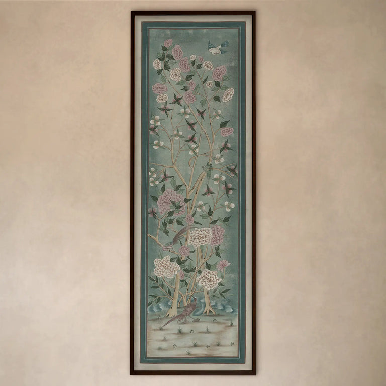 Lemieux et Cie Jardin de Jaipur art panel, vertical framed print depicting flowering branches and birds in soft blue-green tones, hung on warm neutral wall.