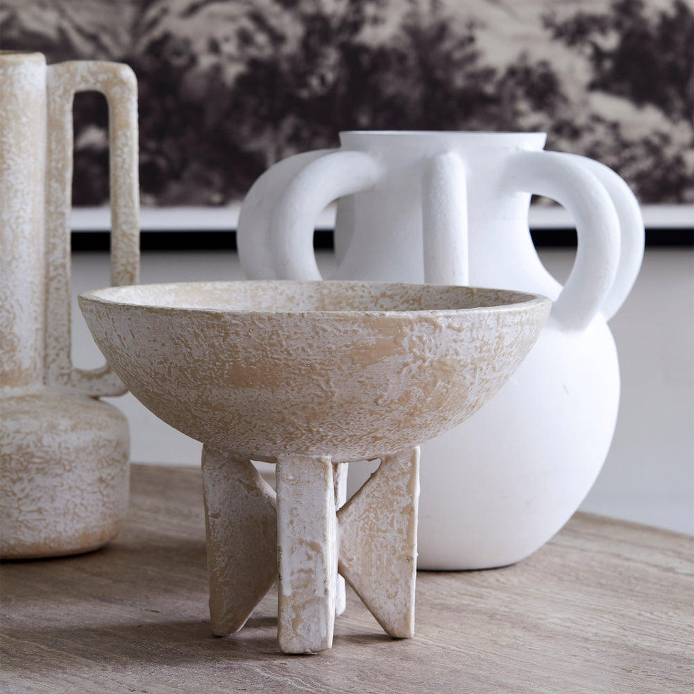 Lemieux et Cie Loire Bowl with hand-shaped organic form and geometric feet, decorative bowl in natural washed finish, styled on stone surface with white sculptural vessels.
