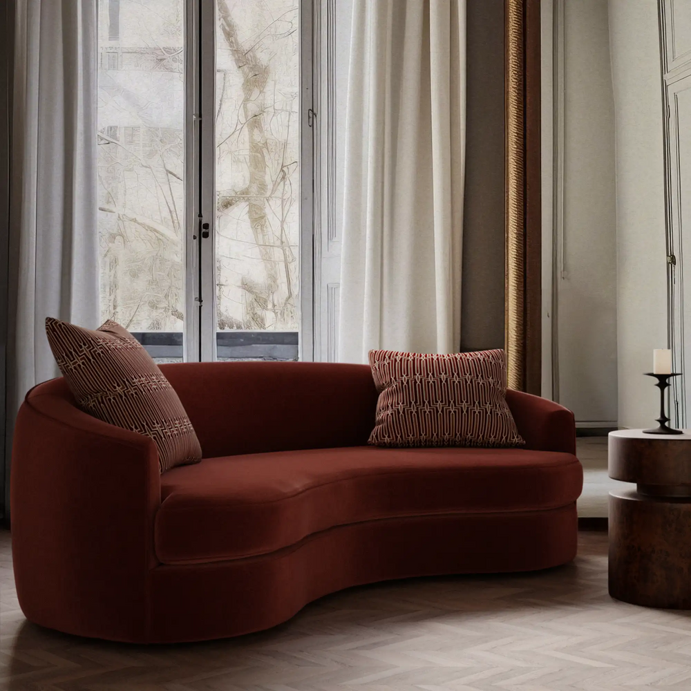 Lemieux et Cie Arbus Stripe Velvet Pillow in burgundy, geometric pillow on curved sofa, bright room with French doors and wood floors.