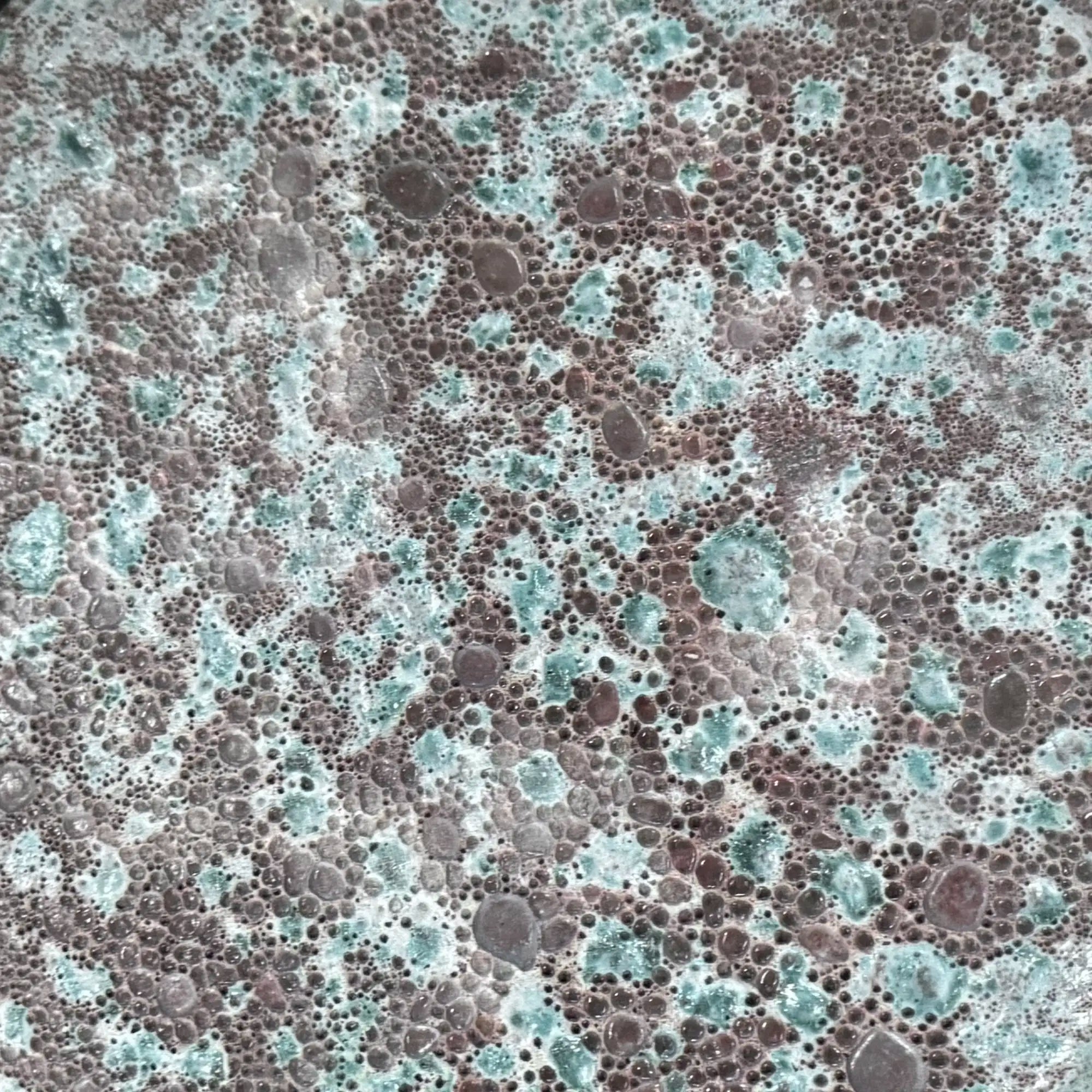 close up showing the glaze and bubbling of the Oxidized Jade ceramic reactive glaze. Handmade for indoor and outdoor use.