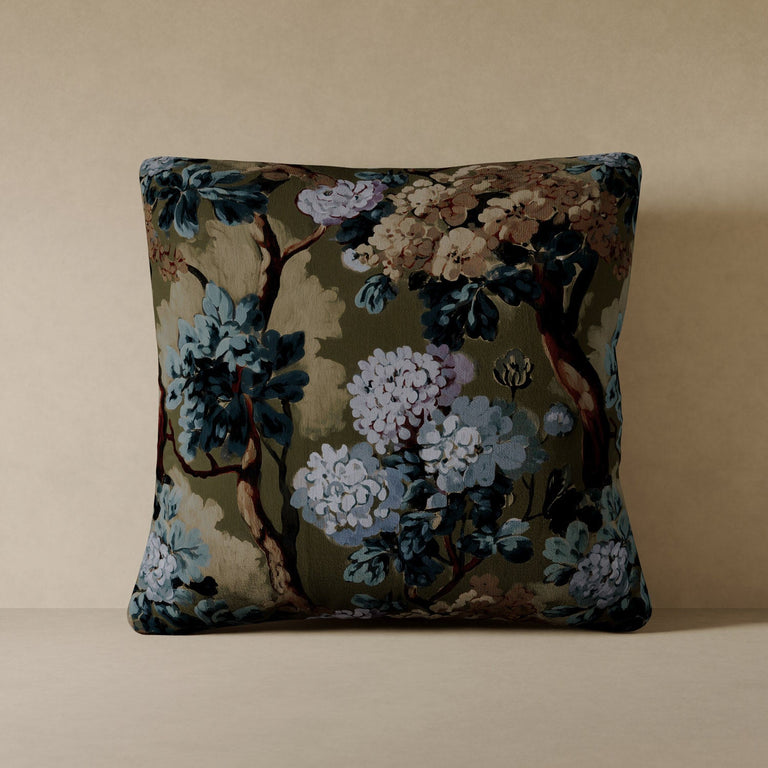 Lemieux et Cie Folie Floral pillow in olive green performance velvet with botanical motif, decorative cushion shown on neutral plaster shelf.