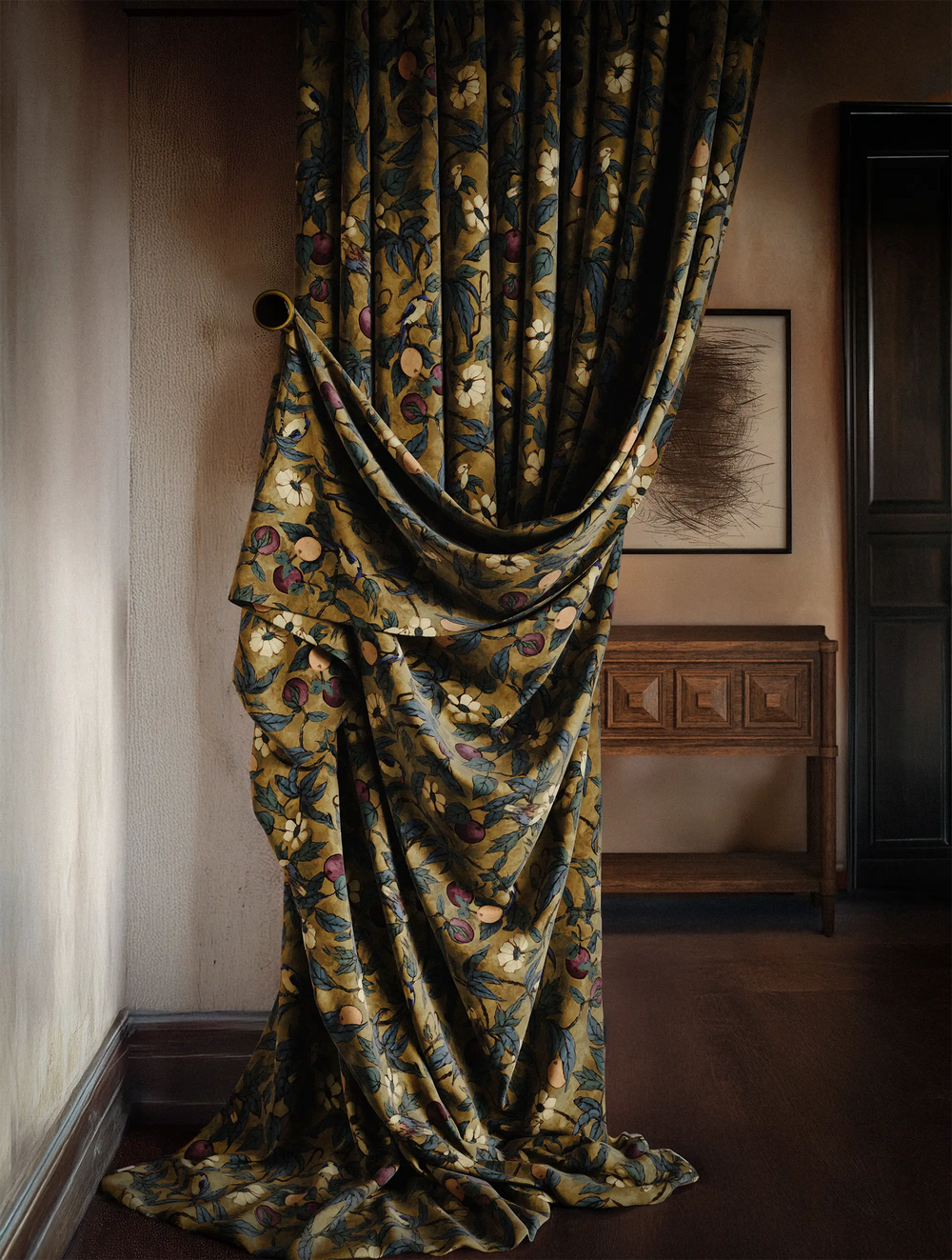 Lemieux et Cie Plum Garden performance velvet drapery in ochre with botanical motif, draped floor-to-ceiling beside carved wood console in warm-lit room.
