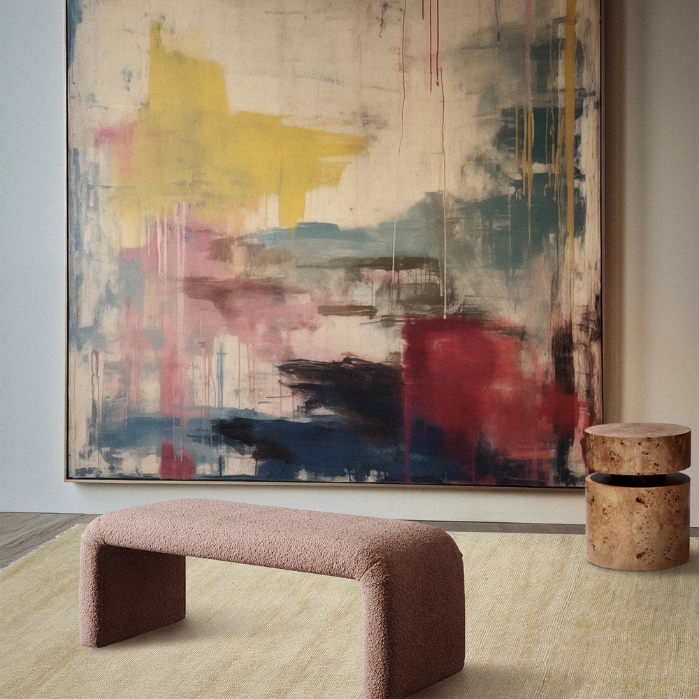 Lemieux et Cie Rochefort Handmade Wool Rug in cream, hand-knotted rug shown beneath abstract painting and bouclé bench in neutral interior with wood flooring.