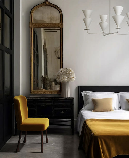Lemieux et Cie Cornet 4 Light Large Chandelier, a luxury lighting fixture hanging above a bed with a Rozette Dining / Side Chair nearby.