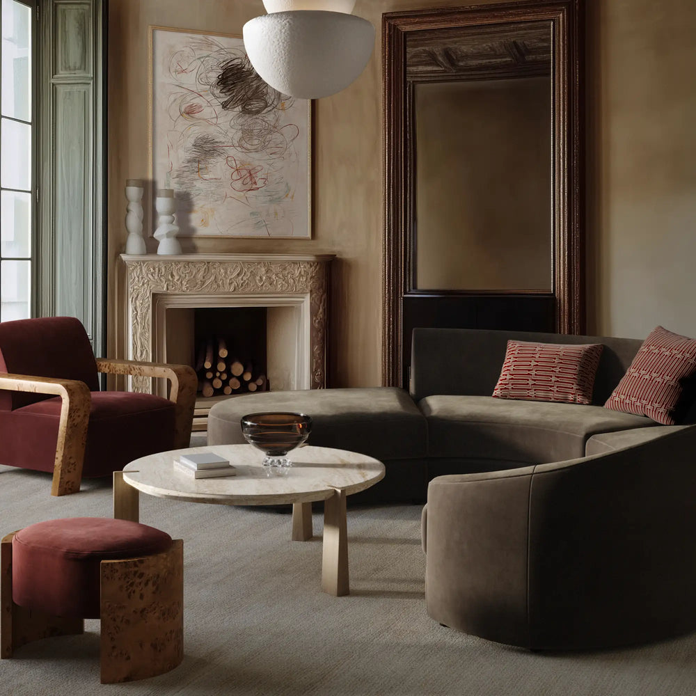 Lemieux et Cie Rulmann 4-Piece Right Sectional, curved modular sofa in olive green, styled in a sitting room with stone fireplace and warm plaster walls.