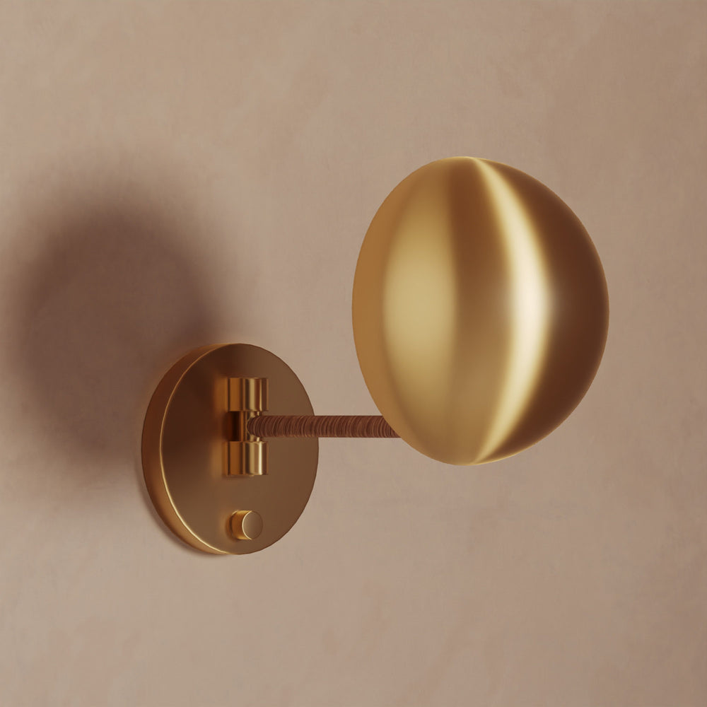 Lemieux et Cie Chambord Sconce in warm brass, sculptural wall light with organic spherical shade and circular backplate on neutral plaster wall.
