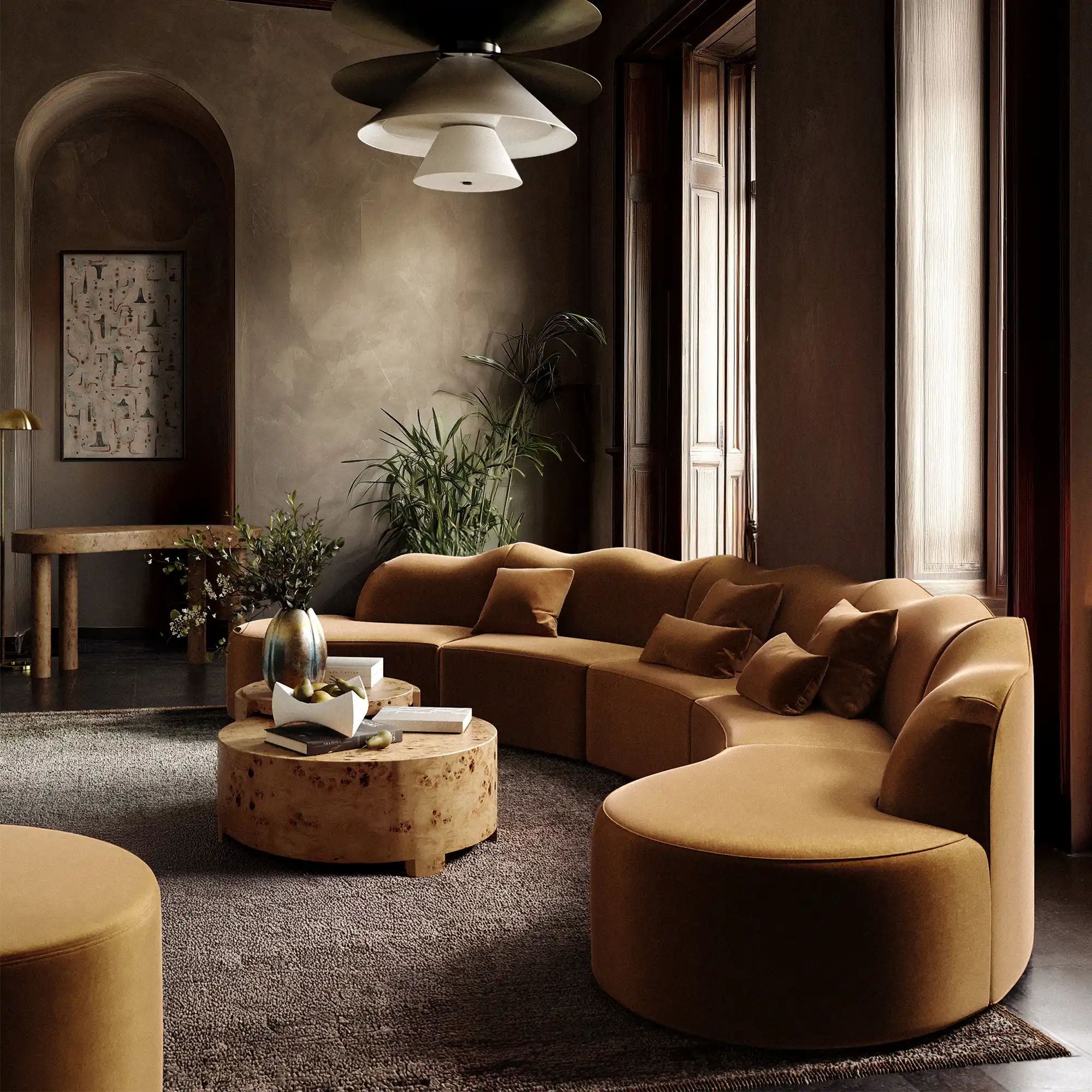Lemieux et Cie Serpentine 4 Piece sectional in nutmeg, curved modular sofa in a high-ceilinged sitting room with plaster walls and wood floors.