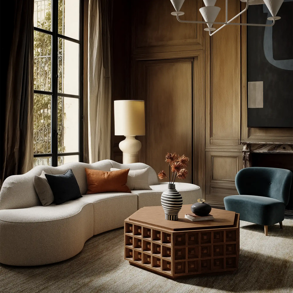 Lemieux et Cie Dubois Hexagonal Coffee Table, geometric grid-front design, shown in a wood-paneled sitting room with curved sofa and tall windows.
