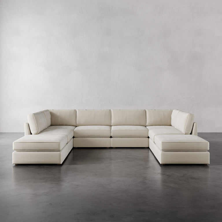 Lemieux Et Cie Chanaux 8-Pc Sectional
Beige sectional sofa on a gray floor with a plain white wall background