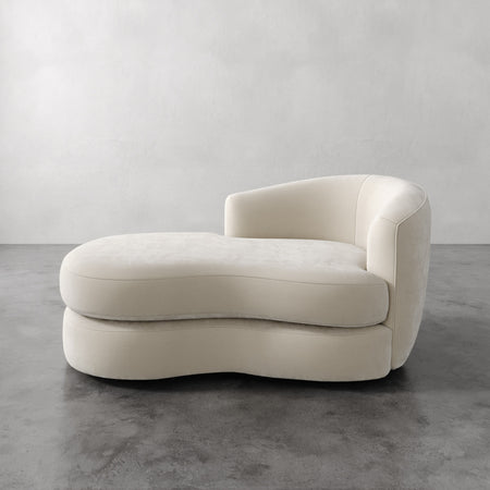 Lemieux et Cie Rulmann Right Arm Chaise in ivory, sculptural low-slung chaise with rounded organic form, on polished concrete floor against neutral plaster walls.