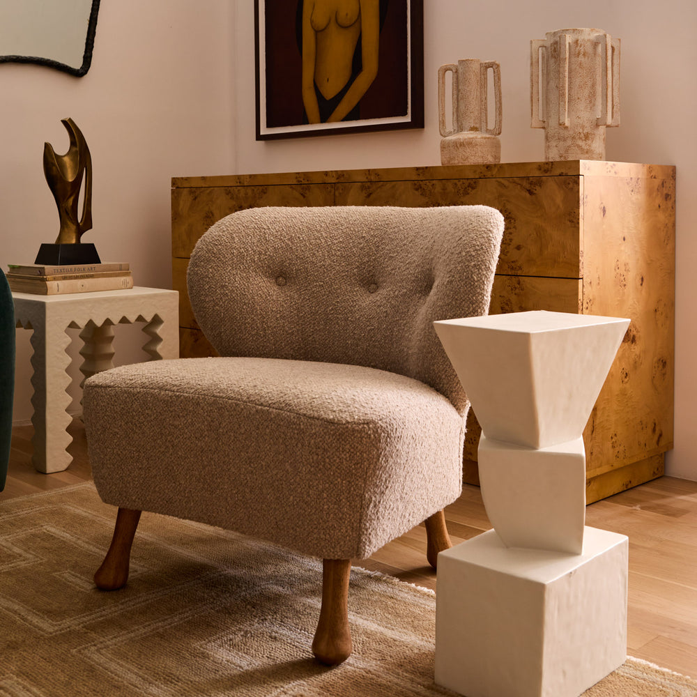 Lemieux et Cie Tourenne Chair in neutral bouclé with sculptural turned legs, lounge chair styled in a curated sitting room with wood floors and warm light.