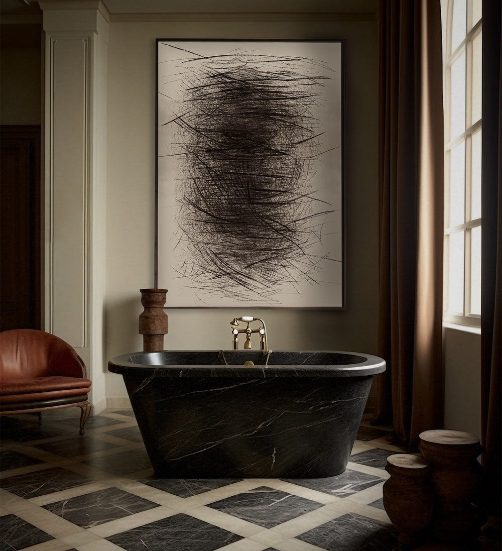 Lemieux et Cie Le Fourré Un abstract art print in charcoal, oil stick and graphite, framed in black, displayed above a marble bathtub in a bathroom with checkered stone flooring.