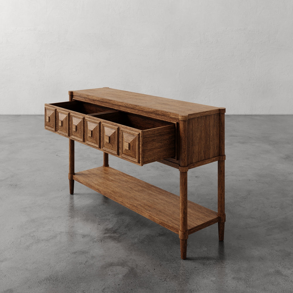 Lemieux et Cie Voltaire Console Table, warm-toned console with geometric drawer fronts and lower shelf, shown on polished concrete floor against neutral plaster walls.