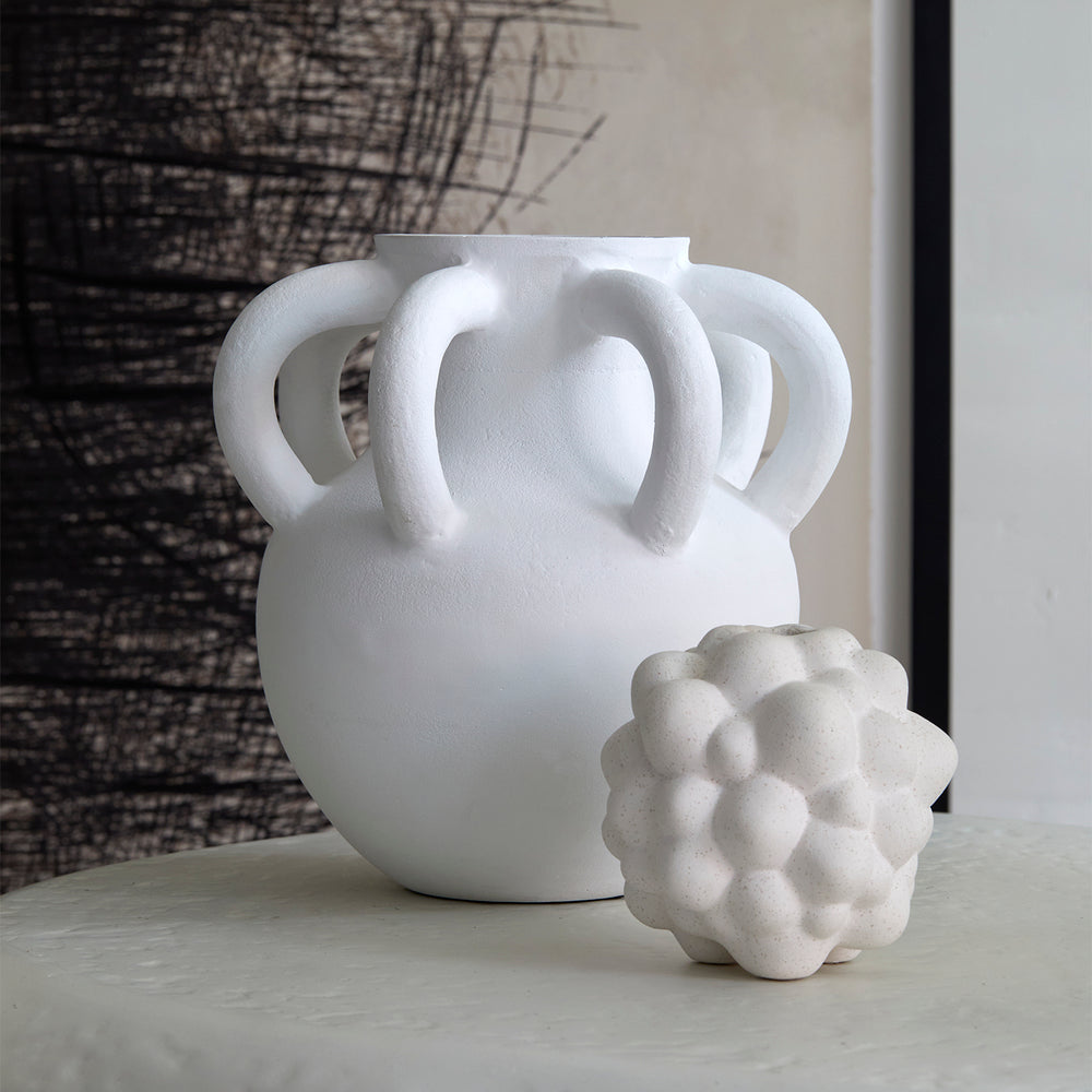 Lemieux et Cie Bubble Vase, sculptural multi-handled form with textured surface, paired with organic sphere vase on neutral stone surface.