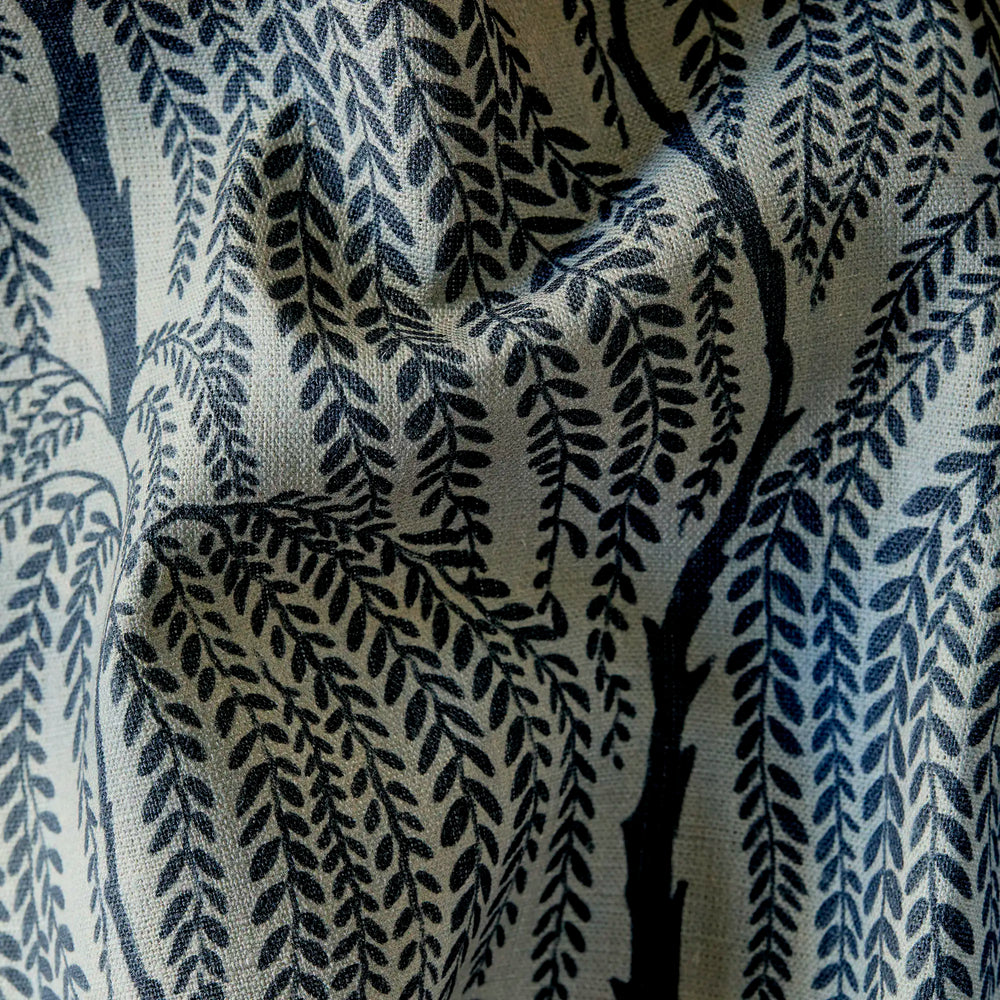 close up of Linen decorative fabric with cascading willow botanical pattern in deep indigo on greige linen ground