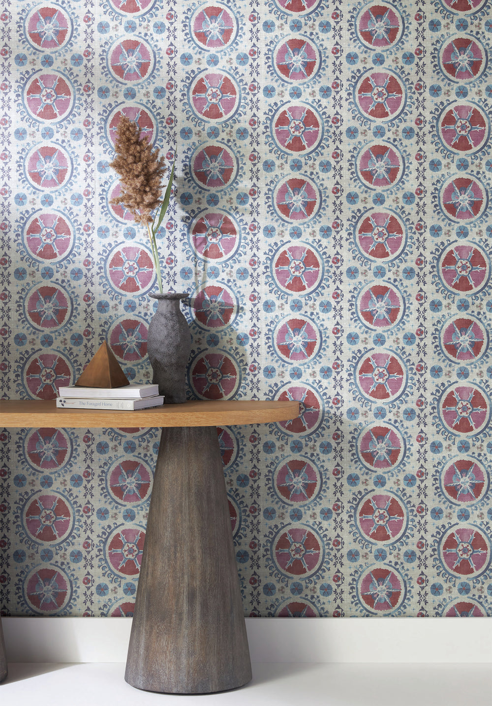 Lemieux et Cie side table in cerused European oak with tapered legs, styled against patterned wallpaper with ceramic vase and dried botanicals.