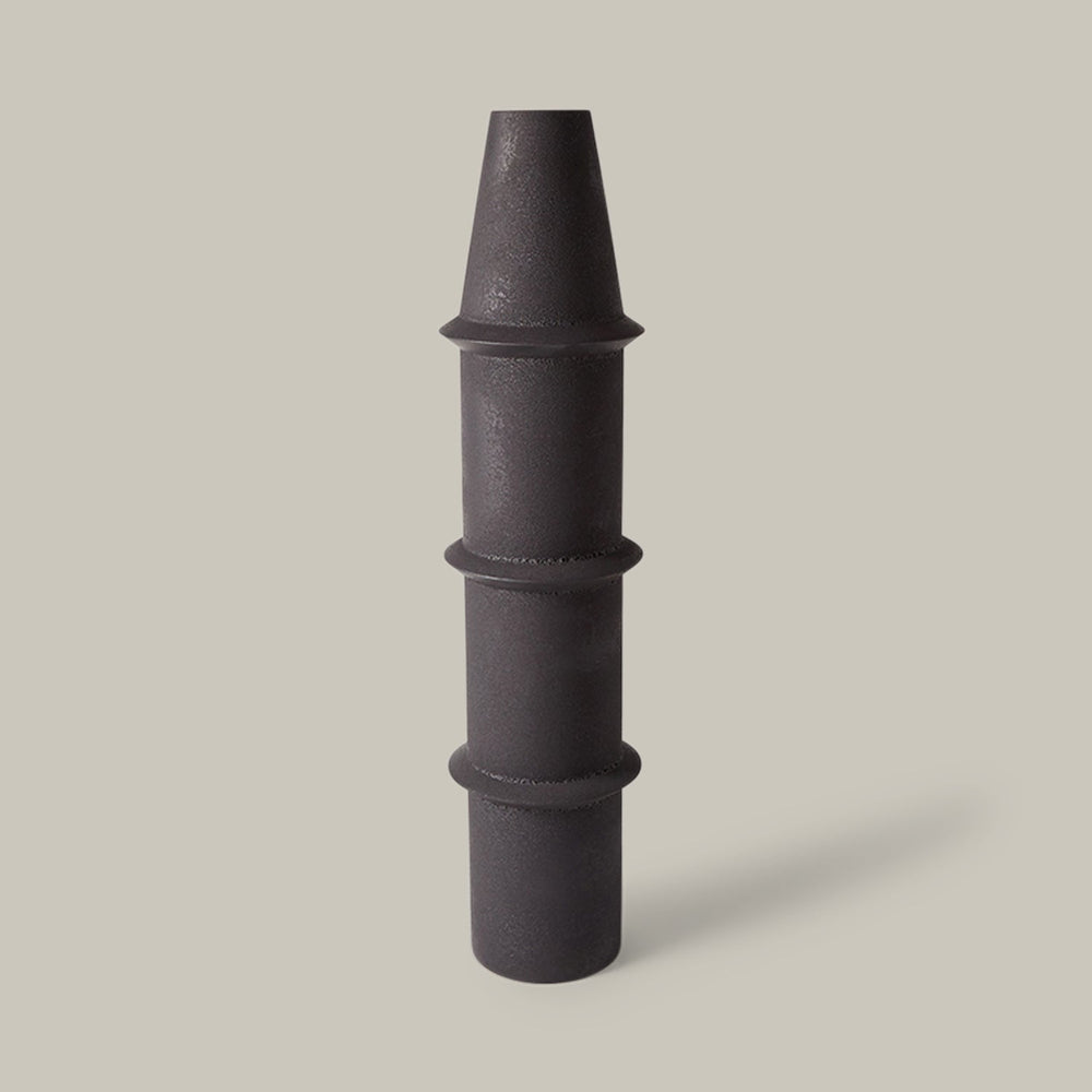 Lemieux et Cie Panisse Vase in black, sculptural stacked form with tapered top and ringed segments, shown on neutral studio backdrop.