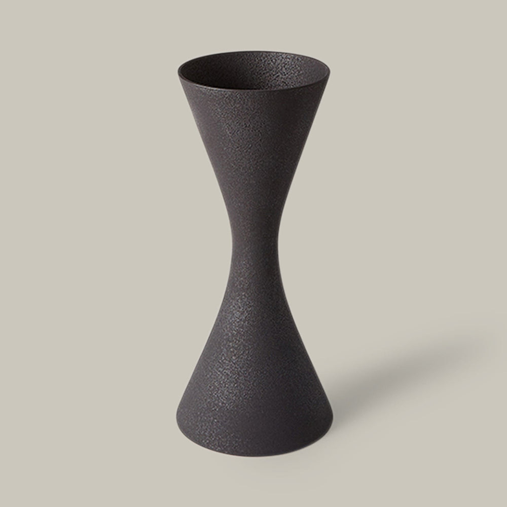 Lemieux et Cie Deoune Vase in black, hourglass-form sculptural vase with textured finish, shown on neutral studio backdrop.