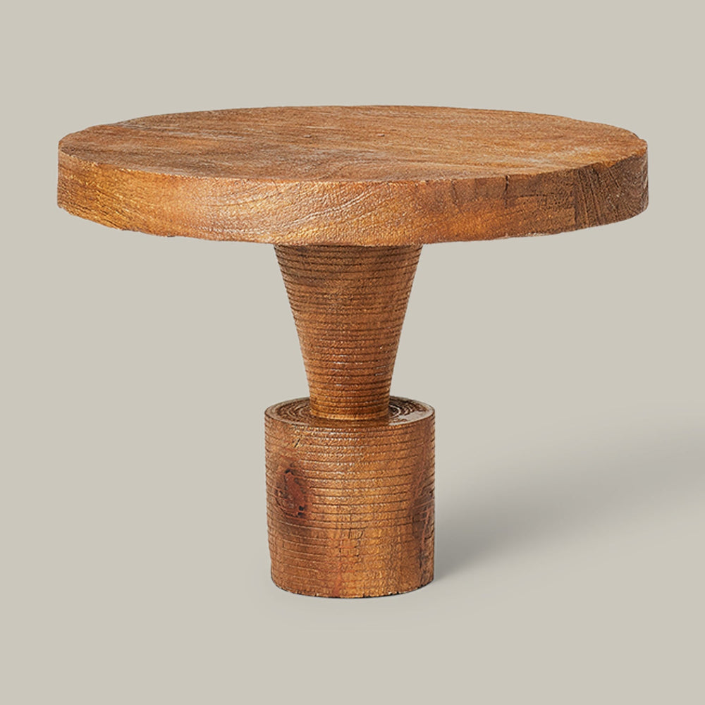Lemieux et Cie Damiette Pedestal, sculptural side table with round top and cylindrical base, shown on neutral studio backdrop.
