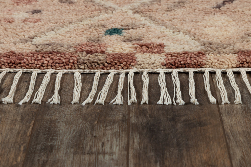 Lemieux et Cie Doukkala Gnibi Rug in natural tones, hand-knotted wool rug with cream fringe detail, shown on aged wood flooring.