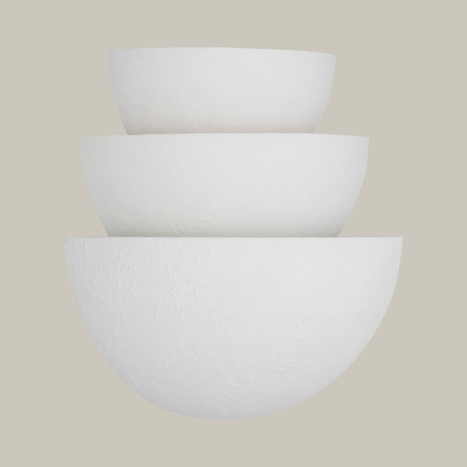 Lemieux et Cie Beaunay Tiered Sconce, a luxury lighting fixture in steel and cast plaster with layered bowl-shaped shades, front view from a slightly lower angle on an off-white background.