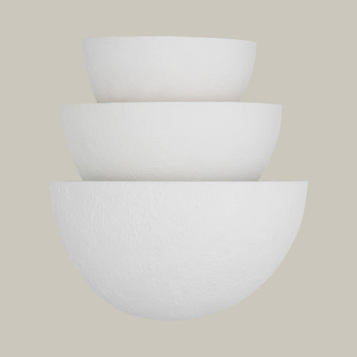Lemieux et Cie Beaunay Tiered Sconce, a luxury lighting fixture in steel and cast plaster with layered bowl-shaped shades, front view from a slightly lower angle on an off-white background.