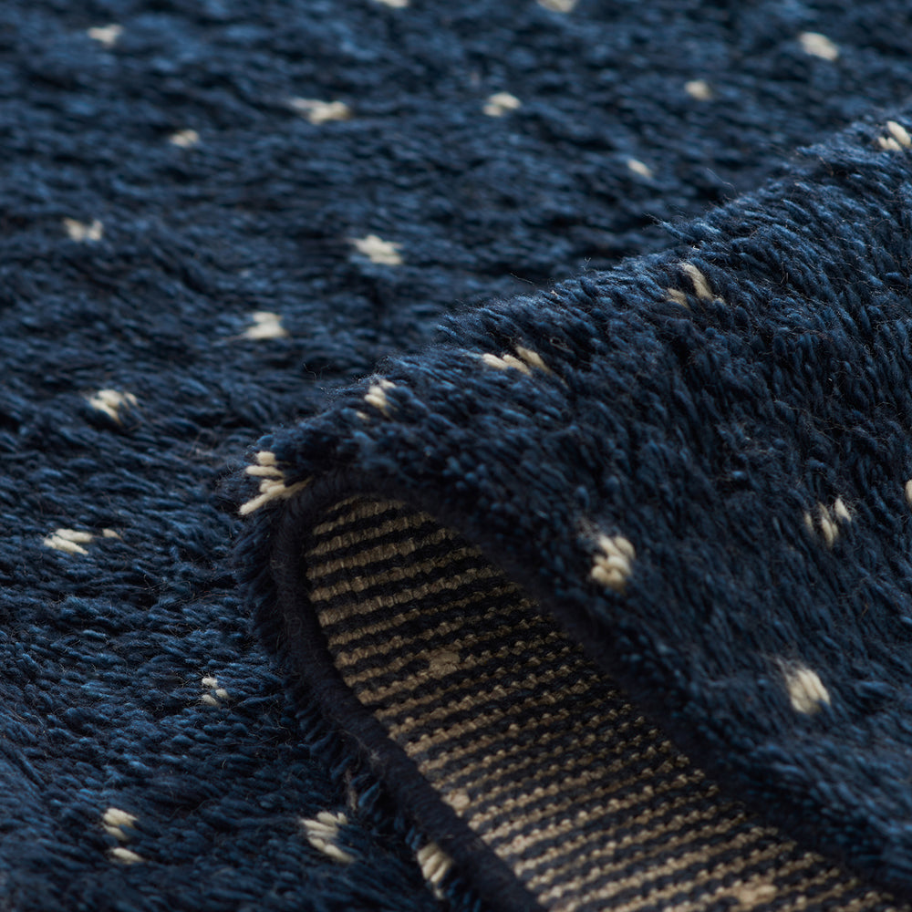 Lemieux et Cie Plivot burnished brass shade detail with perforated pattern, close-up showing conical form and tactile surface texture