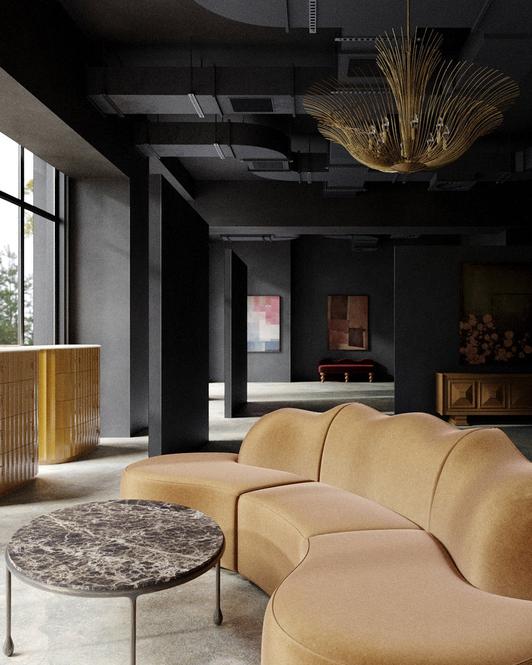 Lemieux et Cie’s new store at 161 Grand Street in Little Paris NYC features a sculptural camel sofa, dark marble table, gold chandelier, and moody black interior.