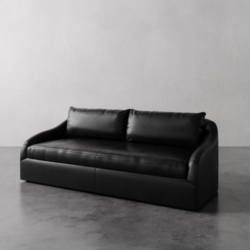 Lemieux Et Cie Black Rousseau Leather Sofa against a plain gray wall