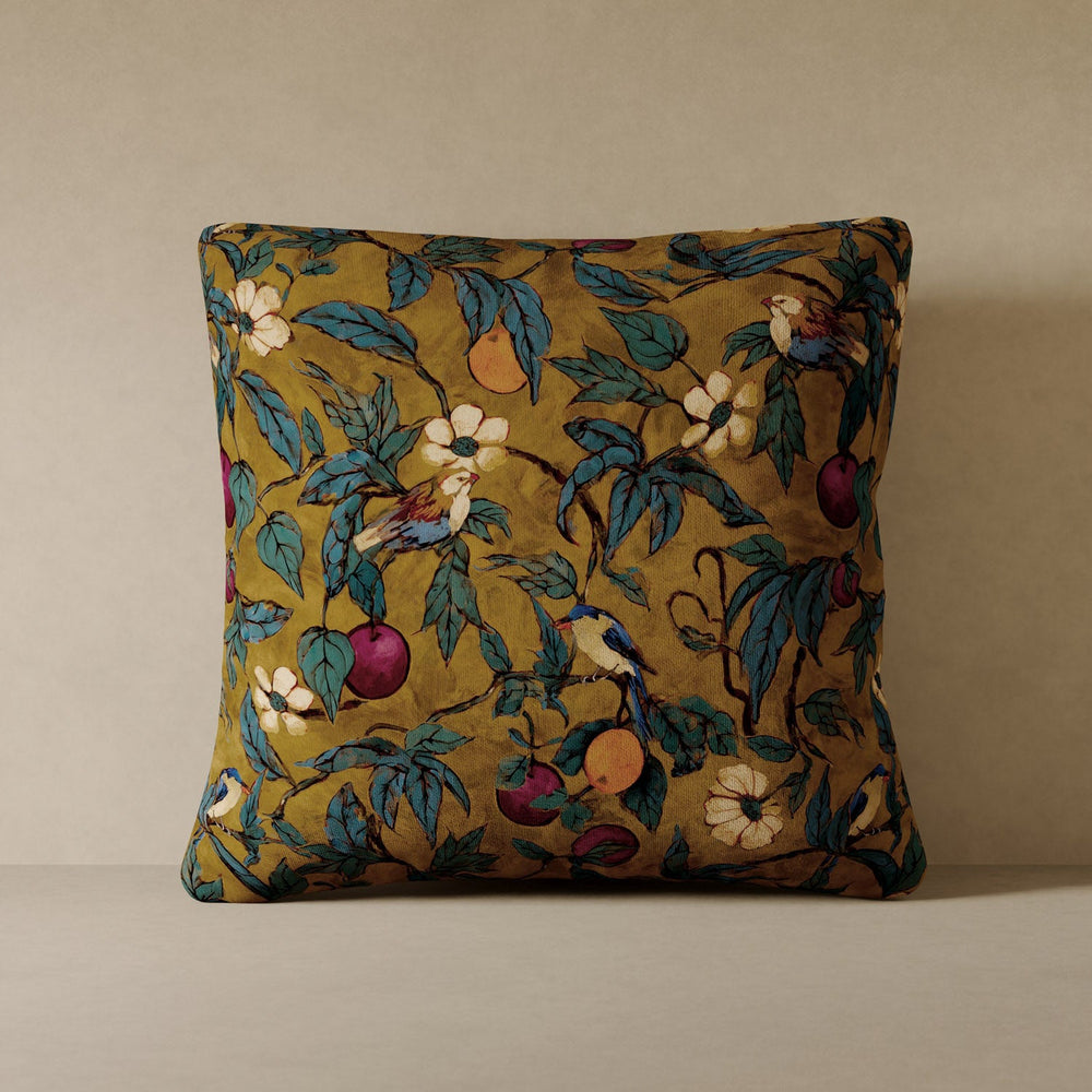 Lemieux et Cie Plum Garden Velvet Pillow in deep ochre with fruiting branch and bird motif, decorative pillow shown on neutral backdrop.