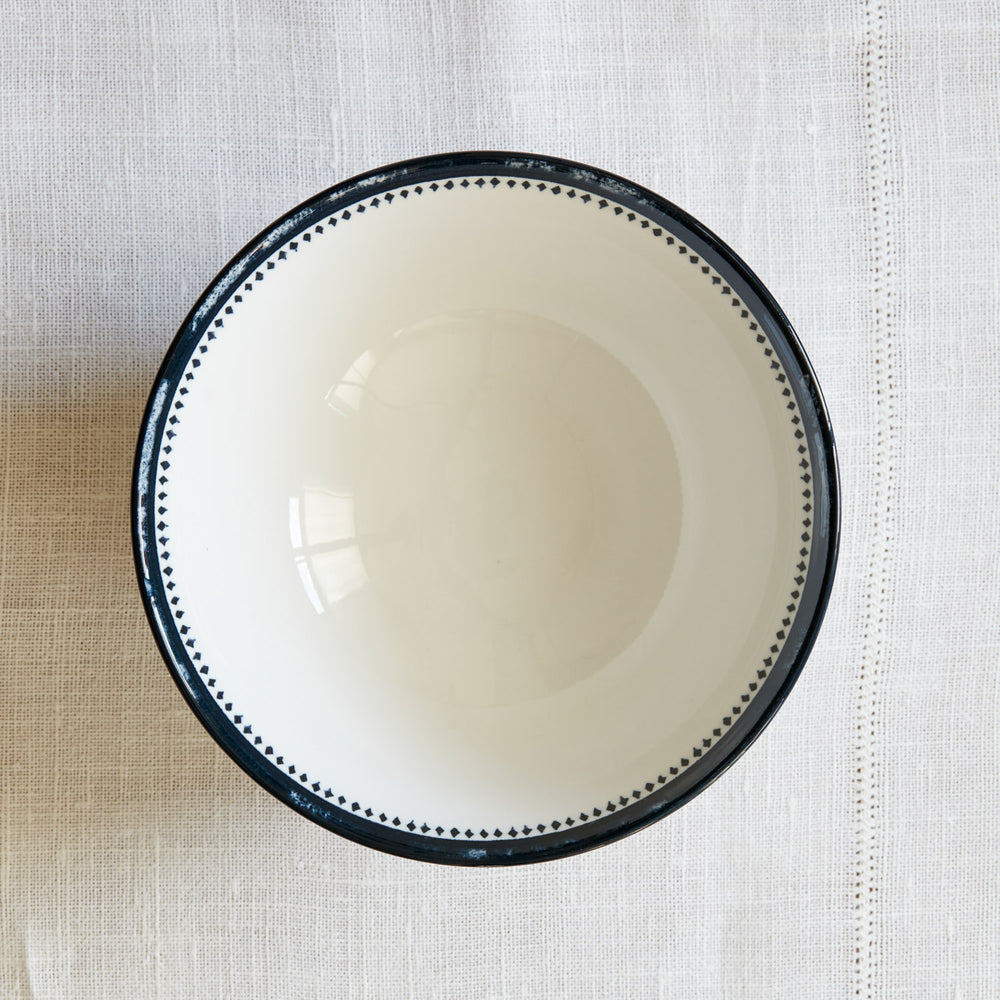 Lemieux et Cie Bruges Porcelain Small Bowl with hand-painted blue detail, ceramic bowl shown on neutral linen textile backdrop.