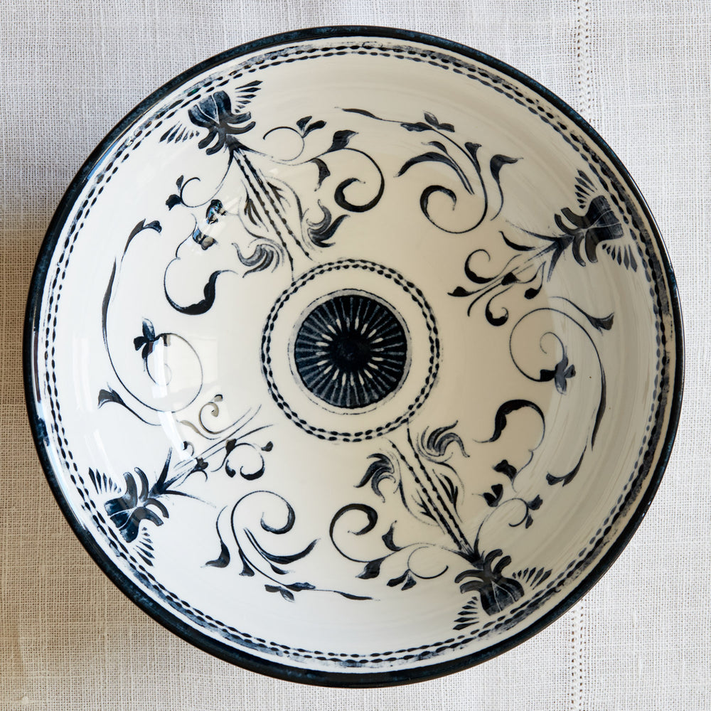 Lemieux et Cie Bruges Porcelain Large Bowl, hand-painted blue and white floral motif ceramic viewed from above on neutral woven textile.