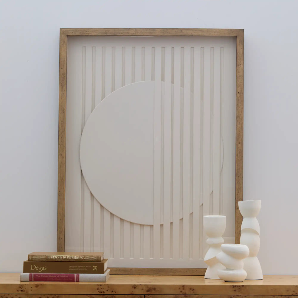 Lemieux et Cie Composition Géométrique No. 1 wall art with framed relief panel and organic circular form, styled on wood shelf with ceramic vessels and books.
