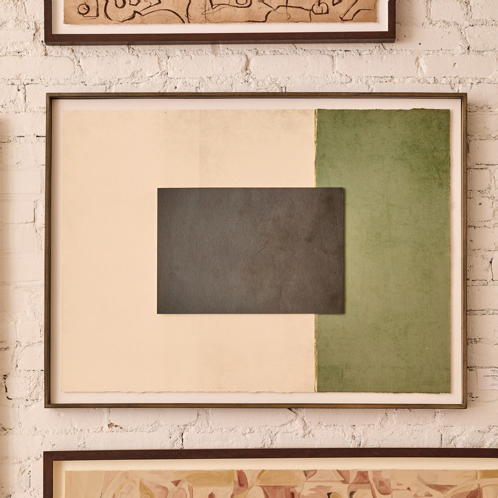 Lemieux et Cie Assemblage Géométrique No. 6, framed abstract composition in charcoal, olive green and cream tones, hung on textured white brick wall.