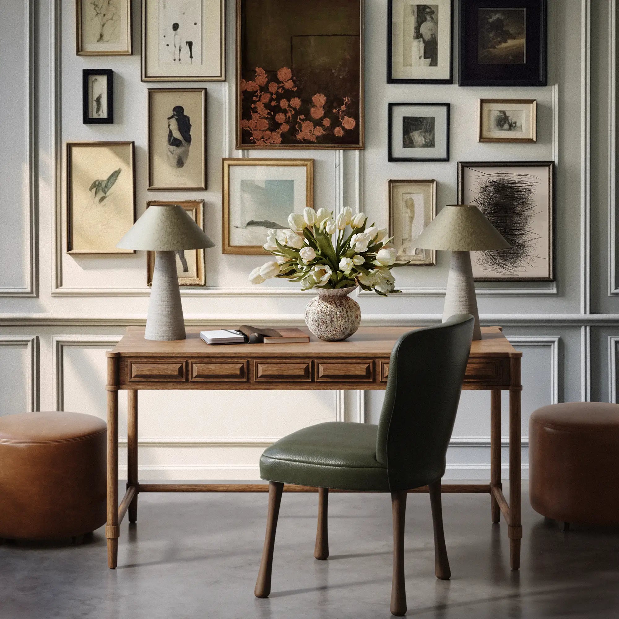 Lemieux et Cie Voltaire Desk in wire-brushed oak, handmade desk with three drawers, shown with green chair and paired lamps in paneled room with gallery wall.