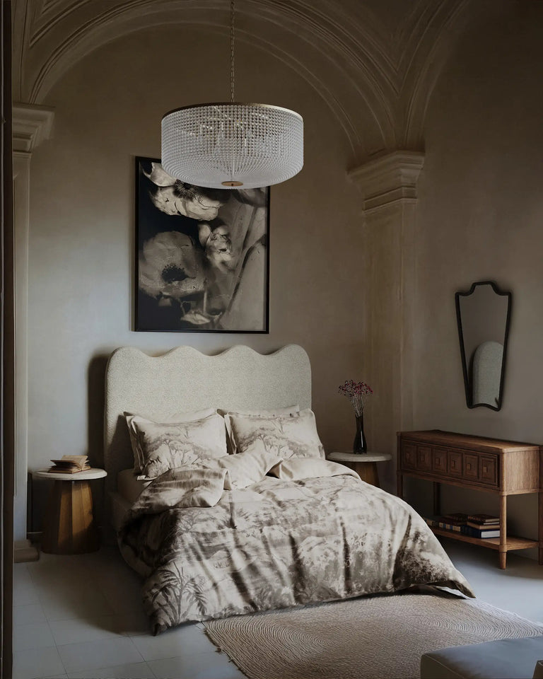 Cozy bedroom with a bed, side tables, and wall art.