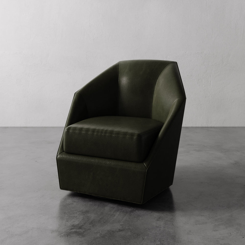 Lemieux et Cie Bijou Swivel Chair in deep olive green leather, geometric angular silhouette, shown on polished concrete floor against white wall.