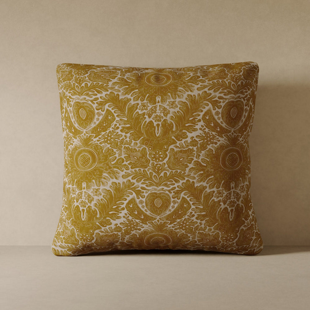 Lemieux et Cie Toile De Rouen Velvet Pillow in saffron and ivory performance velvet, decorative pillow with scrolling botanical pattern, shown against neutral plaster wall