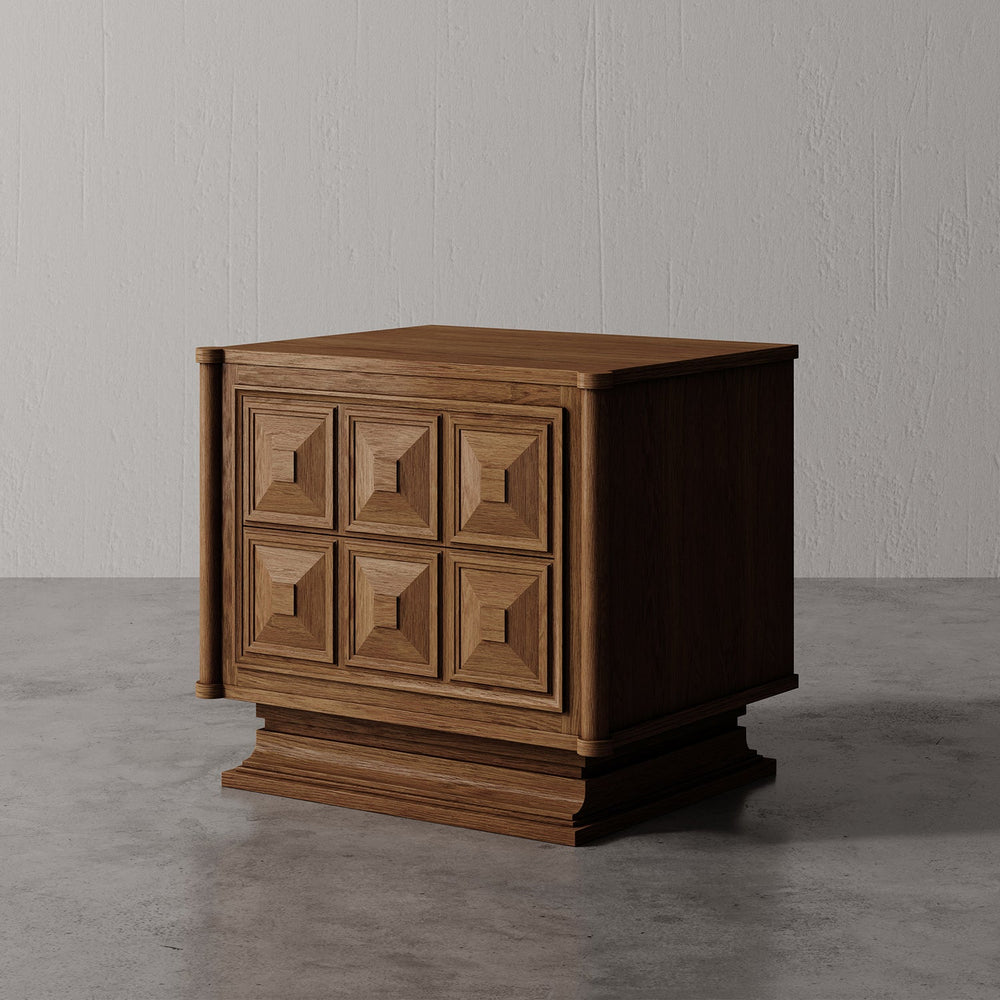 Lemieux et Cie Voltaire Nightstand, hand-crafted cabinet with geometric stepped detailing, shown on concrete floor against neutral plaster walls.