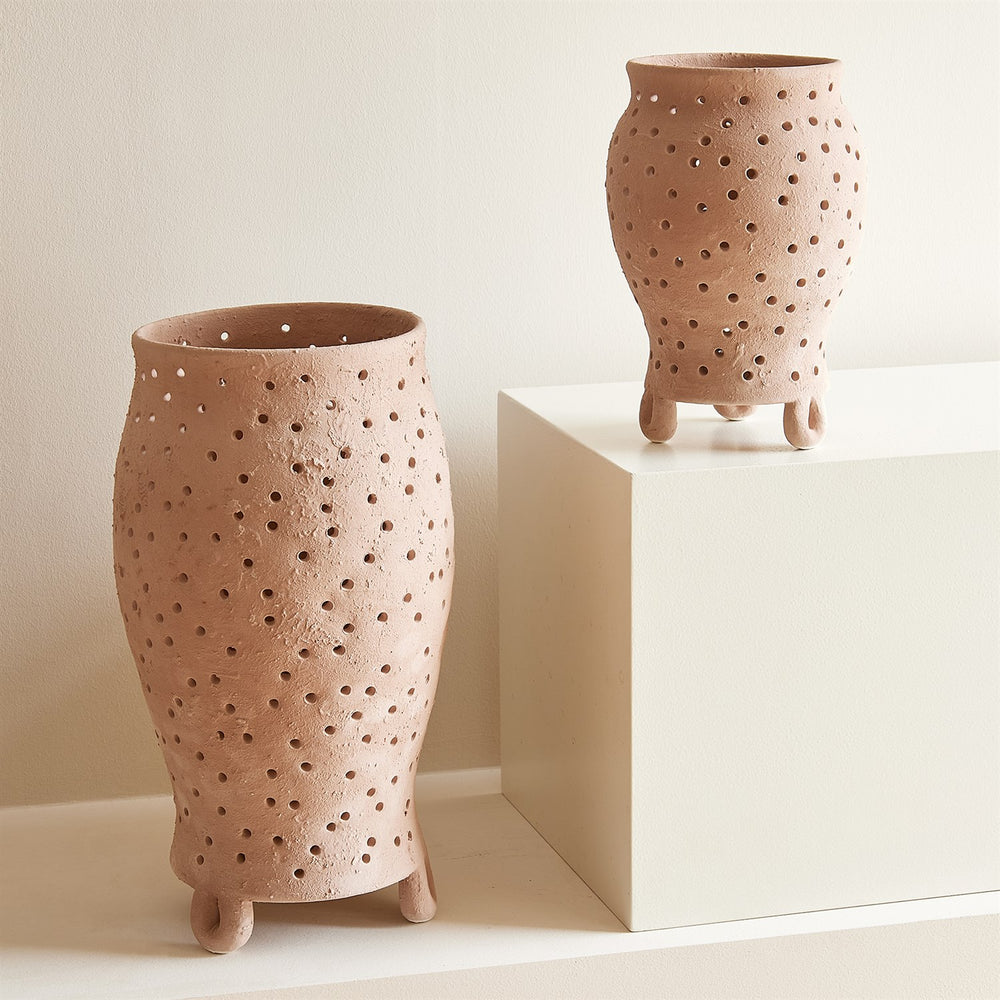 Lemieux et Cie Yassine Candle Holder in Rose, hand-pierced organic vessels with sculptural feet, shown on neutral pedestal against warm white walls.