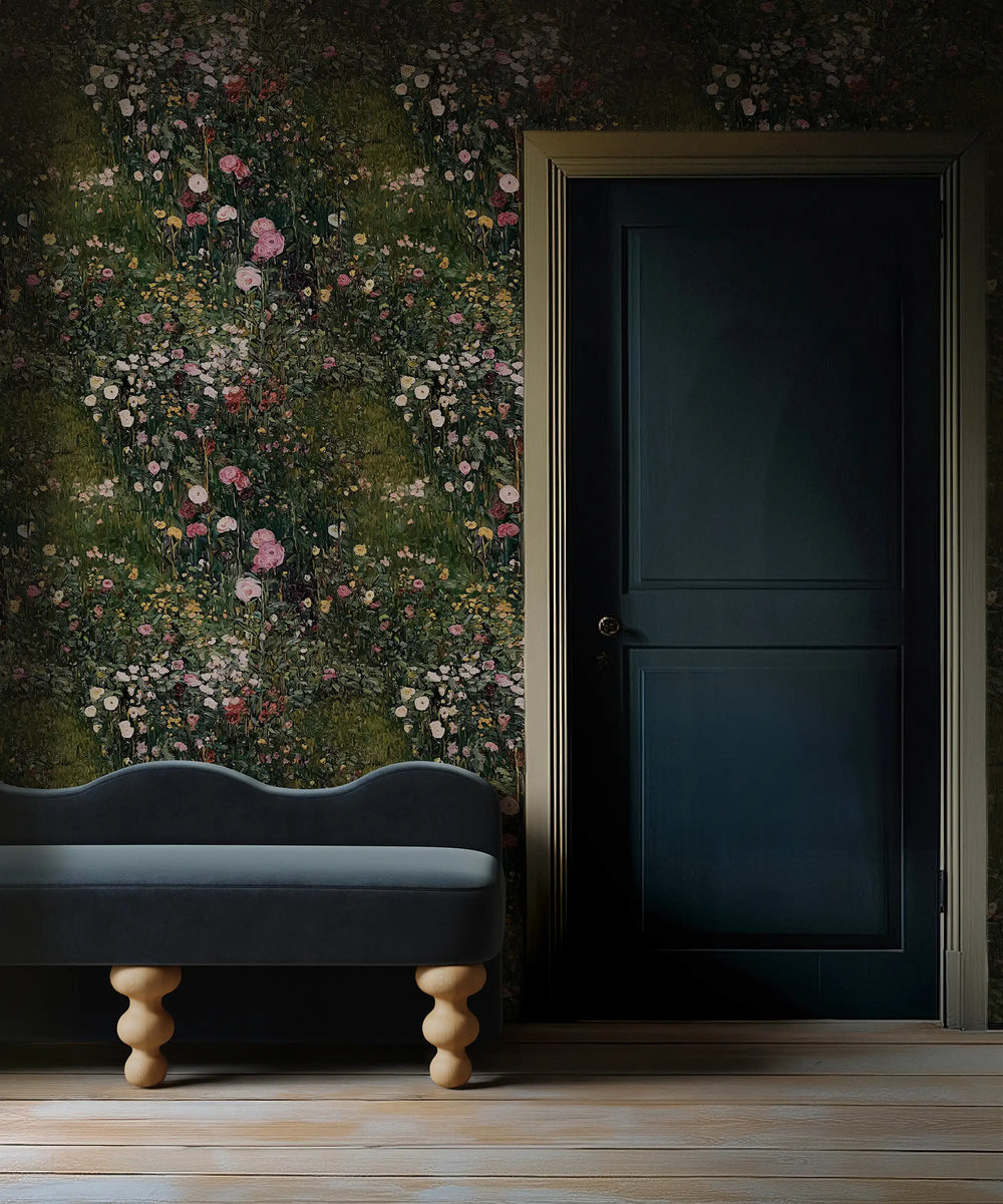Lemieux et Cie April Field Wildflower Wallpaper in pink, rose and ivory on deep green ground, shown in an entryway with dark painted door and wood flooring.