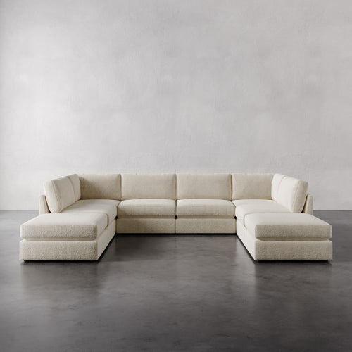 Lemieux Et Cie Chanaux 8-Pc Sectional
Beige sectional sofa on a gray floor with a plain white wall background