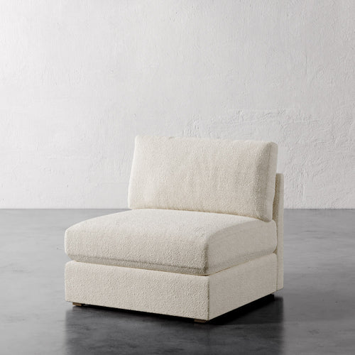 Lemieux Et Cie Chanaux Armless Chair
Beige armchair on a gray floor with a white textured wall background